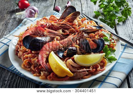 Close-up Of Spanish Fideua, A Noodle Paella With King Prawns, White Fish Meat, Calamari, Mussels Ser