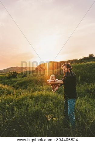 Father Holding Baby Above Grass Walking In Mountains Outdoor Family Lifestyle Dad And Child Travel S