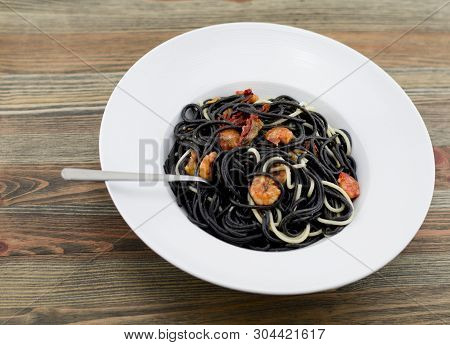 Italian Black Spaghetti, Alla Veneziana, With Grilled Prawns And Dried Tomatoes. With Olive Oil, Gar