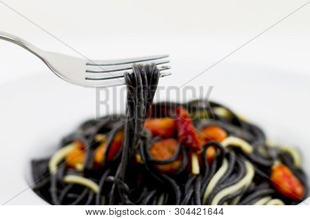 Italian Black Spaghetti, Alla Veneziana, With Grilled Prawns And Dried Tomatoes. With Olive Oil, Gar