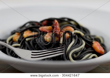 Italian Black Spaghetti, Alla Veneziana, With Grilled Prawns And Dried Tomatoes. With Olive Oil, Gar