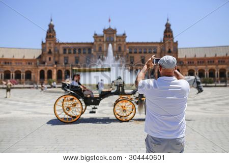 Seville, Spain - July 7th, 2018: Carriage Driver Taking Pciture To Their Costumers In Front Of Plaza