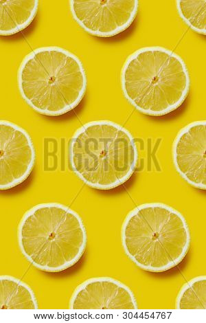Fresh sliced lemon on yellow background, infinite pattern. Seamless background of fresh lemon slices.