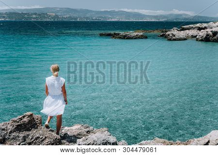 Jung Adult Women In White Dress On Summer Vacation In Front Of Sea Coast Landscape Of Small Beach Wi