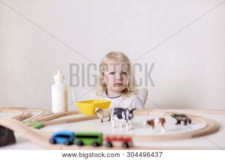 Little Cute Baby Boy (3 Years Old) Drinks Milk With Cookies And Plays In The Wooden Station Train Se