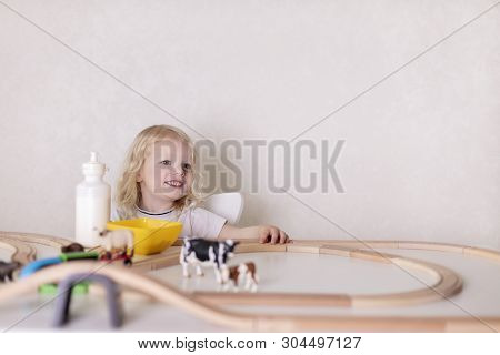 Little Cute Baby Boy (3 Years Old) Drinks Milk With Cookies And Plays In The Wooden Station Train Se