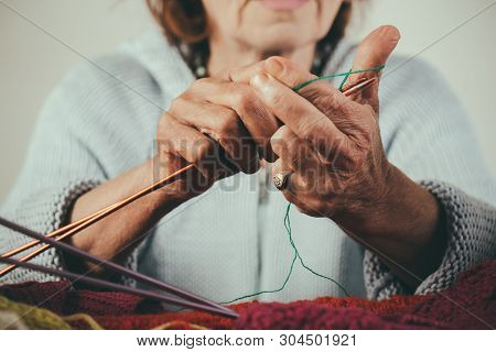 Womens Hands Making Christmas Socks. Gifts For Knitters. Winter Colours. Close-up Of Grandmother Han