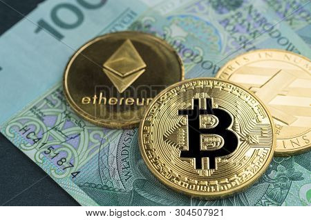 Physical Bitcoin, Litecoin And Ethereum Gold Coins With Polish Currency (pln) On A Black Stone Slate