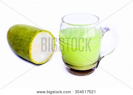 Raw Organic Lauki Or Bottle Gourd Isolated On White With Its Extracted Juice In A Glass Also.