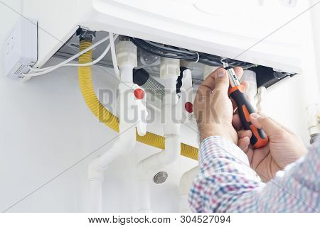 Technician Repairing Gas Heater At Home, Home Appiances Service