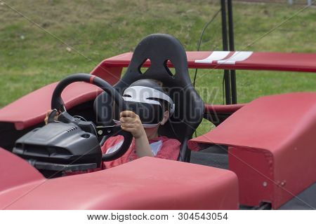 Child Wearing Vr Glasses Driving A Car