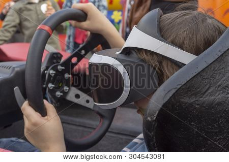 Child Wearing Vr Glasses Driving A Car