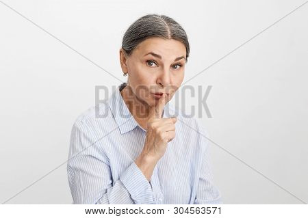 Picture Of Mature Female Executive Office Asking For Silence, Keeping Fore Finger At Her Lips. Beaut