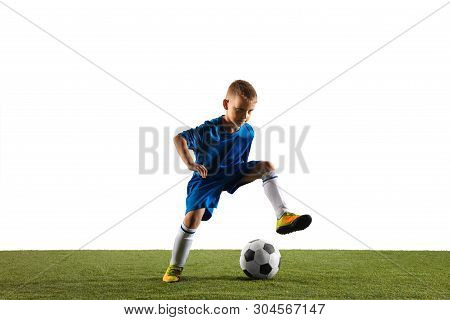 Young Boy As A Soccer Or Football Player In Sportwear Making A Feint Or A Kick With The Ball For A G