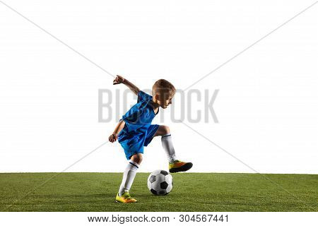 Young Boy As A Soccer Or Football Player In Sportwear Making A Feint Or A Kick With The Ball For A G
