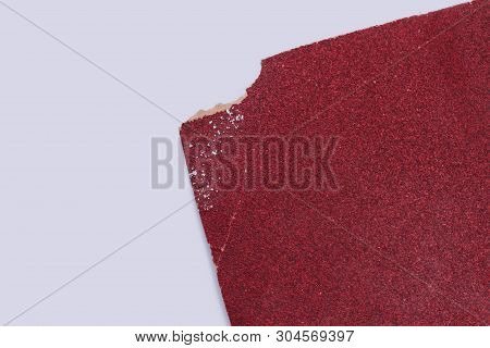 Red Sandpaper Isolated On White Background. Piece Of Abrasive Paper And Copy Space.