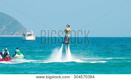 Hainan, Sanya, China - May 14, 2019: Flyboarding. Flying Over The Water On The Board With A Powerful