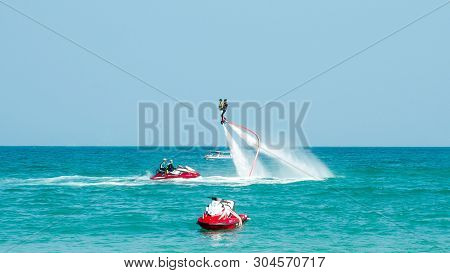 Hainan, Sanya, China - May 14, 2019: Flyboarding. Flying Over The Water On The Board With A Powerful