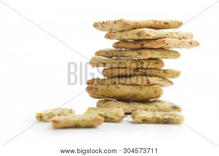 Tasty diet cerel crispbread with seeds and spices: heap of whole  crackers and one broken isolated on a white background