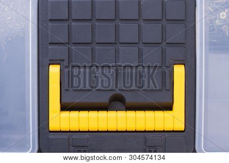 Close Up Black Tool Bix With Yellow Handle. Plastic Tool Kit Box, Macro View.