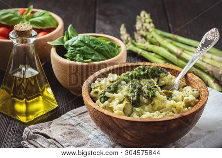 Asparagus And Spinach Risotto , Italian Cuisine, On Wooden Background.