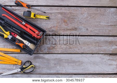 Tool Kit On Wooden Background With Copy Space. Tool Box With Various Construction Tools On Rustic Wo