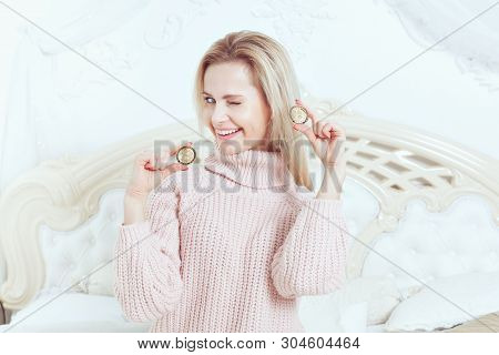Woman Holds A Cryptocurrency And Winks. She Rejoices In Her Hands Bitcoins.