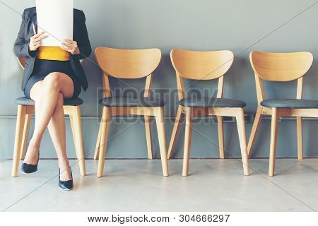 Job Interview. Asian Women Review Document While Waiting For Job Interview Business Concept