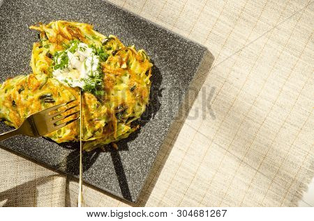 Roesti. Potatoes Grated With Greens, Fried In Butter. Serve On A Stone Board With Sour Cream, Garlic