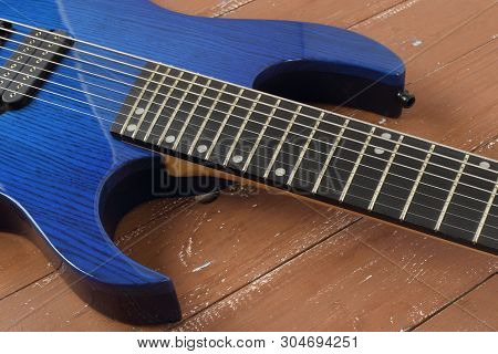Musical Instrument - Fragment 8-string Blue Electric Guitar Solid-body On A Wood Background