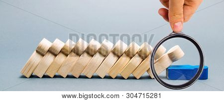 Wooden Figures Of People. Domino Business Concept. The Leader Does Not Stop The Fall Of Employees. W