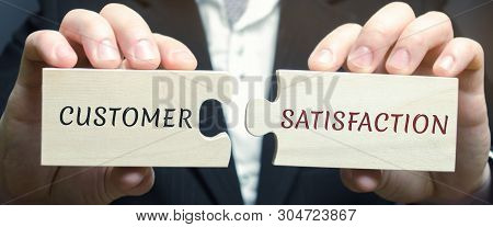 Businessman Collects Wooden Puzzles With The Word Customer Satisfaction ( Csat ). It Is A Measure Of