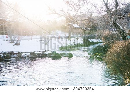 River Mineral Water Stream Flows From Mount Fuji In Oshino Hakkai In Snow Day Flare Light. Tradition