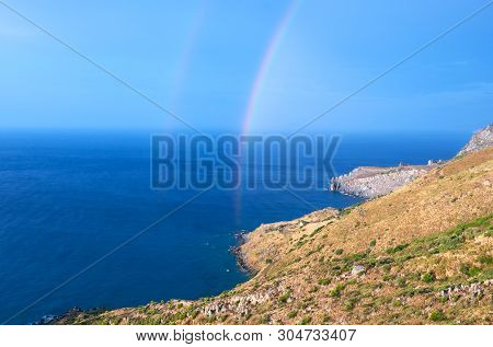Wild Hilly Coastline Of Creta Island After A Rain With A Rainbow