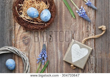 Easter Background With Eggs, Blue Hyacinth Flowers And  Wooden Heart, Top View On Rustic Wood