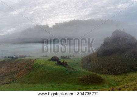 Landscape View Over Iconic House And Tree Covered In Fog At Fundatura Ponorului, Romania