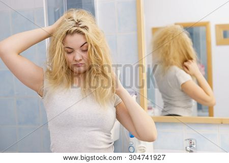 Young Blonde Female Feeling Dull And Tired After Waking Up. Woman Yawning Being Sleepy In Bathroom.
