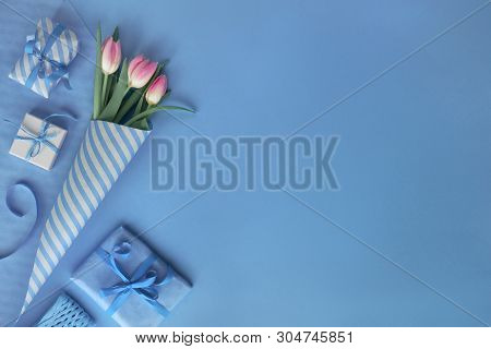 Blue Background With Pink Tulips, Stripy Wrapping Paper And Wrapped Gift Boxes, Copy-space