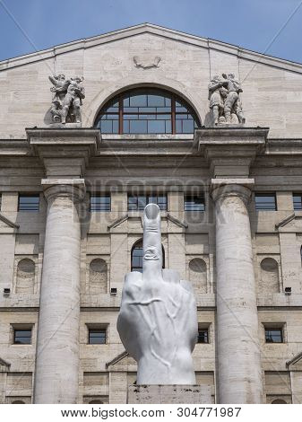 Milan, Italy - May 25, 2019: Mezzanotte Palace Facade And Middle Finger Sculpture In Milan Stock Exc