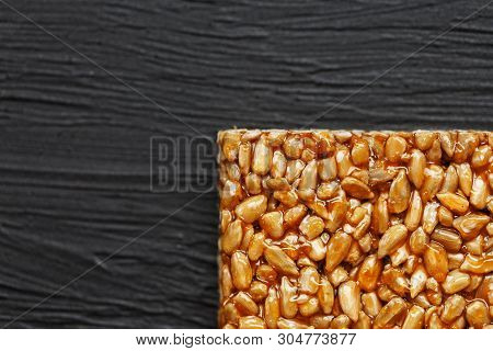 Tile Kozinaki From Sunflower Seeds On A Black Textural Background. Delicious Oriental Sweets Gozinak