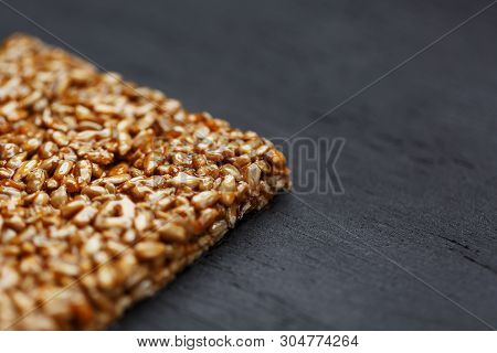 Tile Kozinaki From Sunflower Seeds On A Black Textural Background. Delicious Oriental Sweets Gozinak