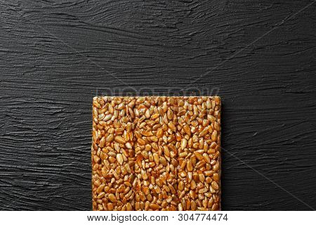 Tile Kozinaki From Sunflower Seeds On A Black Textural Background. Delicious Oriental Sweets Gozinak