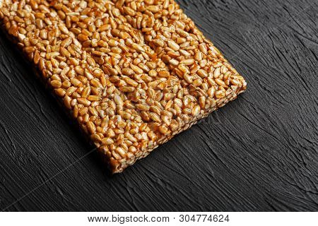 Tile Kozinaki From Sunflower Seeds On A Black Textural Background. Delicious Oriental Sweets Gozinak