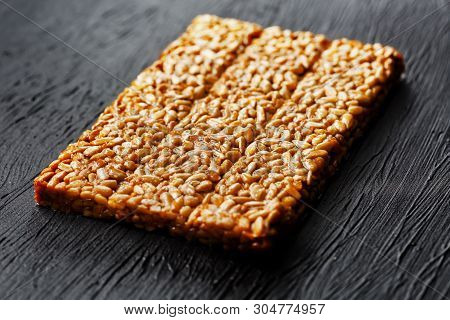 Tile Kozinaki From Sunflower Seeds On A Black Textural Background. Delicious Oriental Sweets Gozinak