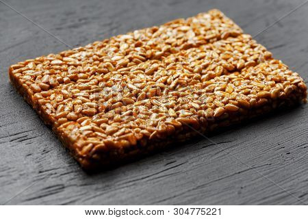 Tile Kozinaki From Sunflower Seeds On A Black Textural Background. Delicious Oriental Sweets Gozinak