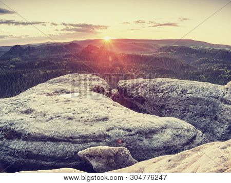 Peak Of Sandstone Rock With View Into Colorful Mist In Morning Valley. Blue Eyllow Daybreak Sun Hidd