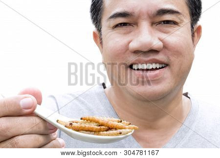 Food Insect: Man Hand Holding Spoon Eating Bamboo Worm Insect Or Bamboo Caterpillar Deep-fried As Fo