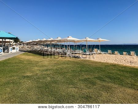 Nikiti Beach Is In The Village Of Nikiti With Sun Beds And Umbrellas, Sithonia Peninsula, Chalkidiki