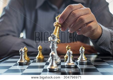 Gold And Silver Chess With Player, Intelligent Businessman Playing Chess Game Competition To Plannin