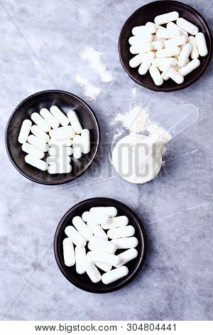 Scoop Of Whey Protein, Hydrolyzed Collagen Type I, L-proline And L-lysine Capsules. Supplements To S